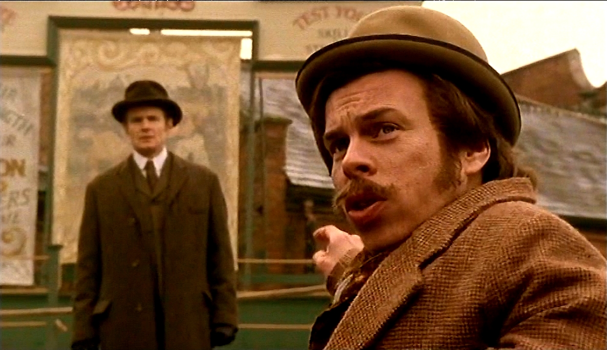 Charles Edwards and Warwick Davies in a fairground scene from the BBC Films series Murder Rooms